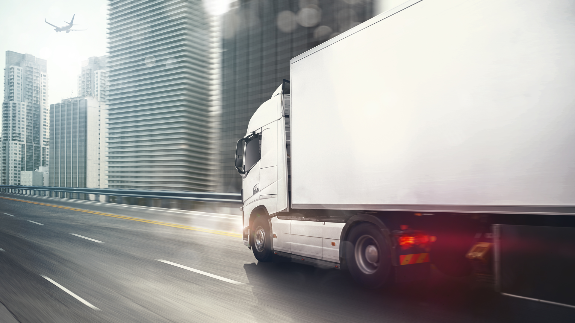 A truck going very fast on the highway